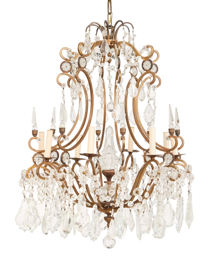 French Bronze and Crystal Chandelier: French Bronze and Crystal Chandelier of Louis XIV Inspiration 20th century, the eight-light chandelier with a scrolled bronze frame decorated at the top with inset molded glass medallions, hung with s