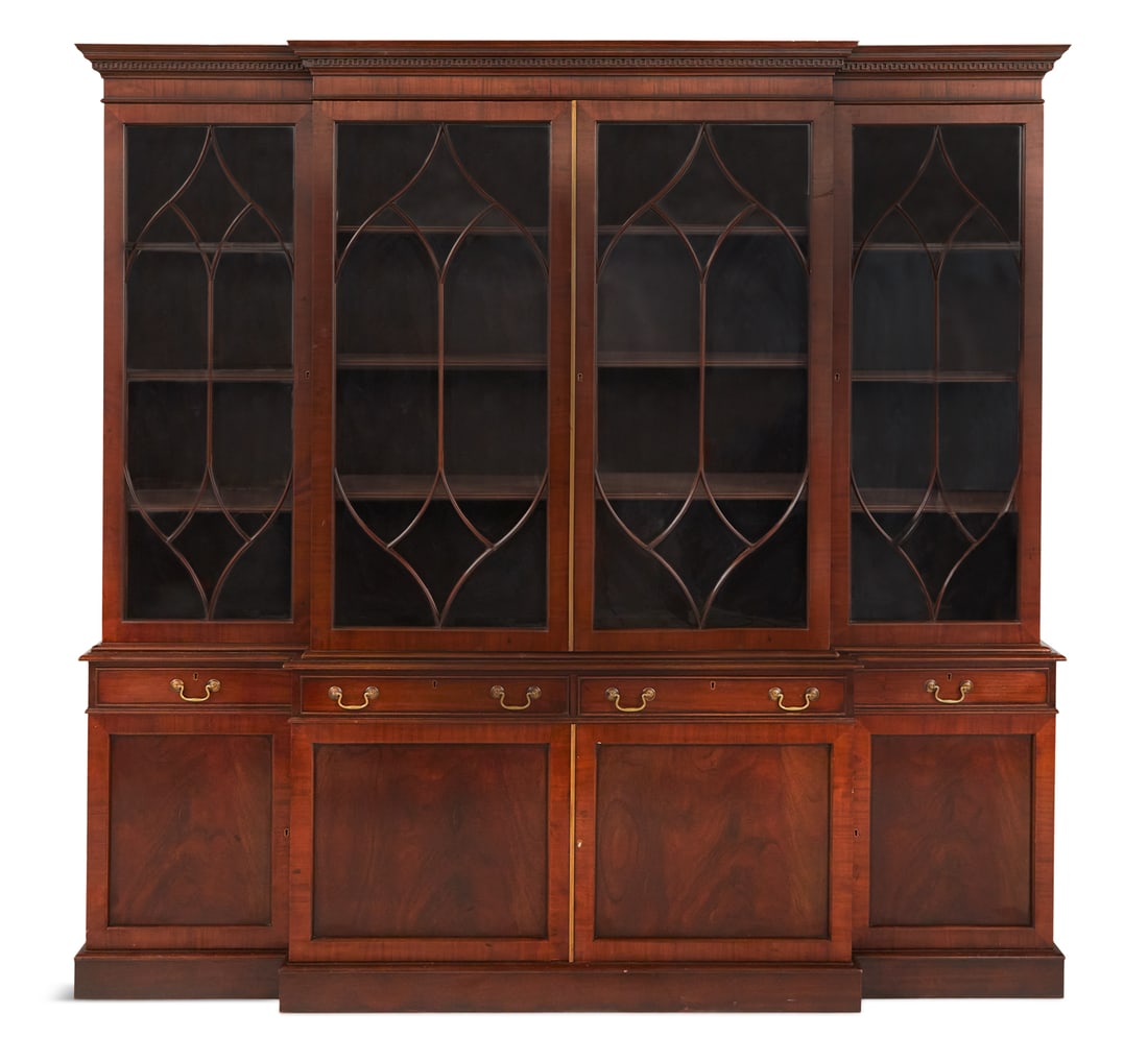 George III-Style Mahogany Breakfront: George III-Style Mahogany Breakfront 20th century, the molded and dentillated cornice above a case fitted with four astragal-glazed doors, the lower section fitted with four drawers over paneled cupbo