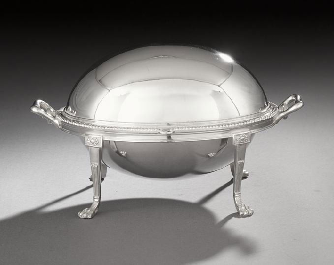 George V Silverplate Revolving Vegetable Dish: George V Silverplate Revolving Vegetable Dish, first quarter 20th century, by Martin, Hall & Co., of oval form with gadrooned rim, raised on four flat columnar legs with patera crests and lion's paw f