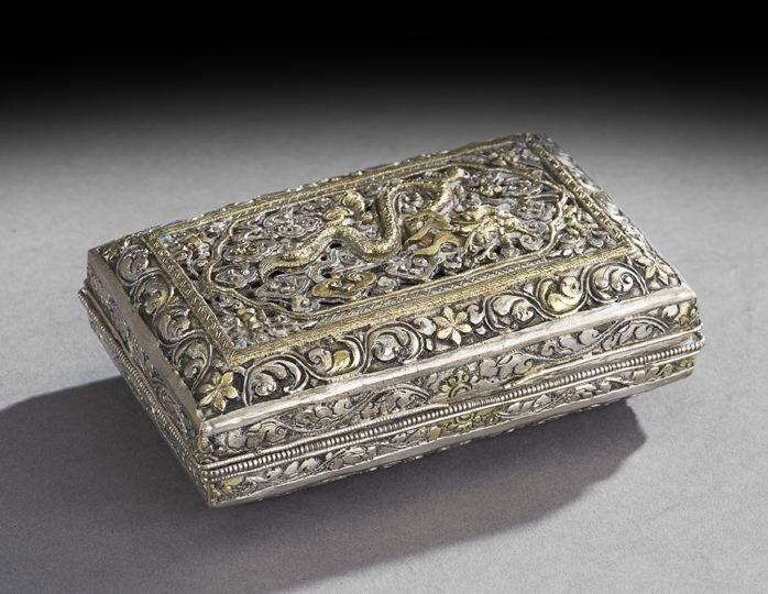 Chinese Silver Box: Chinese Silver Box, 20th century, the parcel-gilt box with repousse decoration of a dragon, clouds and scrolling, h. 1-1/2", w. 4-1/4", d. 3".