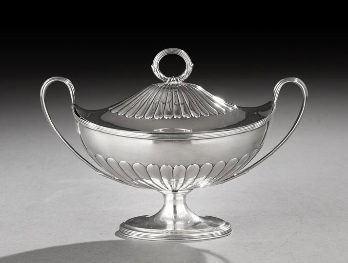 George III Sterling Silver Sauce Tureen: George III Sterling Silver Sauce Tureen, hallmarked London, 1795-1796, by Henry Chawner, of oval form, the lower half gadrooned, with a reeded rim and arched handles on the narrow ends, fitted with a