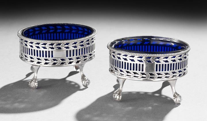 Pair of Hester Bateman Sterling Salt Cellars: Pair of George III Hester Bateman Sterling Silver Salt Cellars, hallmarked London 1779-1780 and 1781-1782, each of oval form, decorated with openwork lattice and laurel banding, with beaded rim and ra