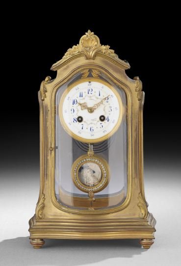 Louis XV-Style Gilt-Bronze Clock: Louis XV-Style Gilt-Bronze Clock, ca. 1900, retailed by J.E. Caldwell, Philadelphia, the case with a serpentine facade top and sides, the corners decorated with scrolls and all inset with complex beve
