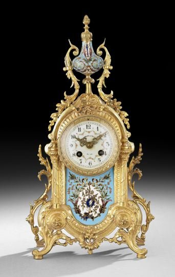 French Gilt-Brass and Champleve Mantel Clock: French Gilt-Brass and Champleve Enamel Mantel Clock, ca. 1900, the elaborately cast case resting on scrollwork feet, with a pierced skirt, reeded sides columns and a bowknot crest, the lower facade mo