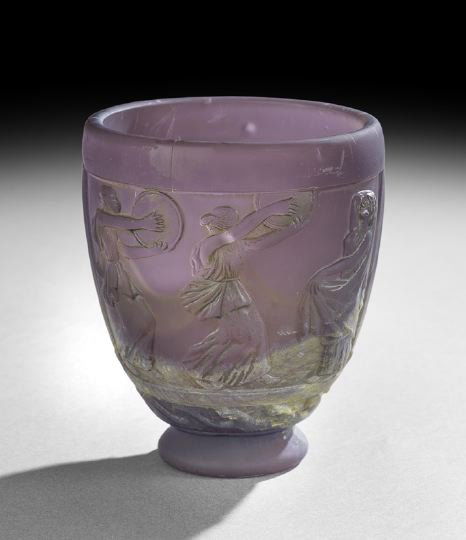 George de Feure Molded Art Glass Vase: George de Feure Molded Art Glass Vase, first quarter 20th century, the vase executed in purple and green mottled glass, molded with bas relief images of maidens in classical costume, dancing and playi