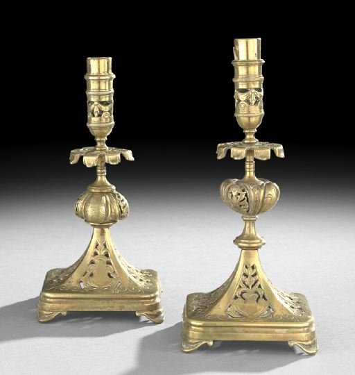 Near Pair of Edwardian Brass Candlesticks: Near Pair of Edwardian Brass Candlesticks in the Elizabethan-style, first quarter 20th century, the pierce and engraved tapering square base decorated with cartouches and strapwork, the bulbous shaft 