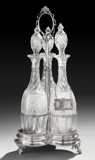 Victorian Silverplate Decanter Frame: Victorian Silverplate Decanter Frame, fourth quarter 19th century, of trefoil form, with a central standard surmounted by a scrolling oval ring handle and surrounded by three circular wire receptacles
