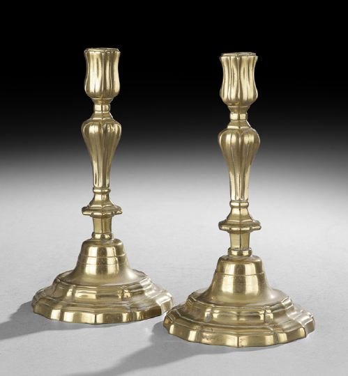 Pair of French Louis XV Brass Candlesticks: Pair of French Louis XV Brass Candlesticks, third quarter 18th century, the domed base stepped and molded in a repeating ogee curve, the vase-shaped standard with alternating ribs and indentations, an