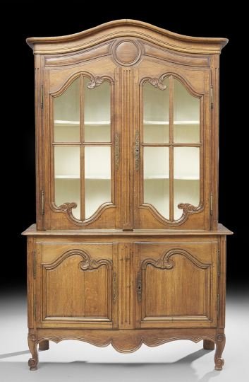 Provincial Louis XV-Style Oak Cabinet: Provincial Louis XV-Style Oak Cabinet, mid-19th century, the domed and molded cornice above a case fitted with two astragal-glazed doors, the lower section fitted with two cupboard doors, each inset w