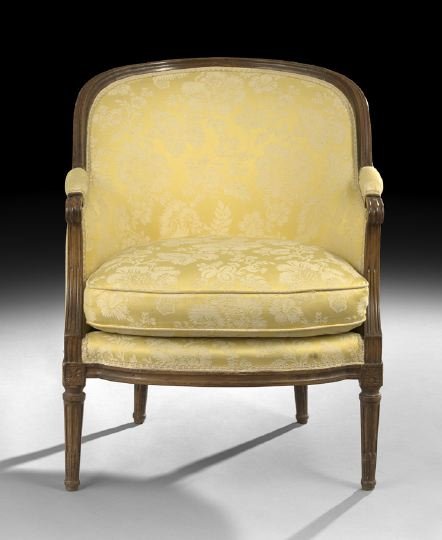 Louis XVI-Style Fruitwood Bergere: Louis XVI-Style Fruitwood Bergere, early 20th century, the padded and domed downswept back and sides above the cushioned seat, raised on tapering circular stop-fluted legs headed by floral block capit