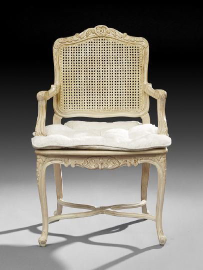Provincial Louis XV-Style Polychrome Fauteuil: Provincial Louis XV-Style Polychrome Fauteuil, the shaped and caned back surmounted by a floral and foliate crest, joined to the cushioned caned seat by molded arms, raised on cabriole legs joined by