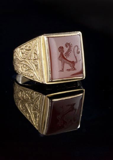 Italian 18 Kt. Gold and Carnelian Intaglio Ring: Italian Eighteen Karat Yellow Gold and Carnelian Intaglio Ring, second quarter 20th century, with a rectangular carnelian intaglio engraved with a seated sphinx, bezel set in a conforming gold mount w
