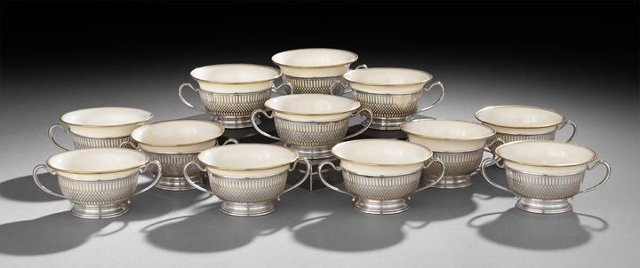 Twelve Sterling and Porcelain Bouillon Cups: Set of Twelve Sterling Silver and Porcelain Bouillon Cups, mid-20th century, the silver frames by Frank M. Whiting, North Attleboro, Massachusetts, the porcelain cups by Lenox, Trenton, New Jersey, th