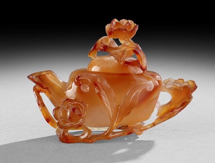 Chinese Hardstone Ewer: Chinese Hardstone Ewer, late 19th century, the ewer in carnelian carved with flowers, h. 3-1/2", w. 4-1/2".