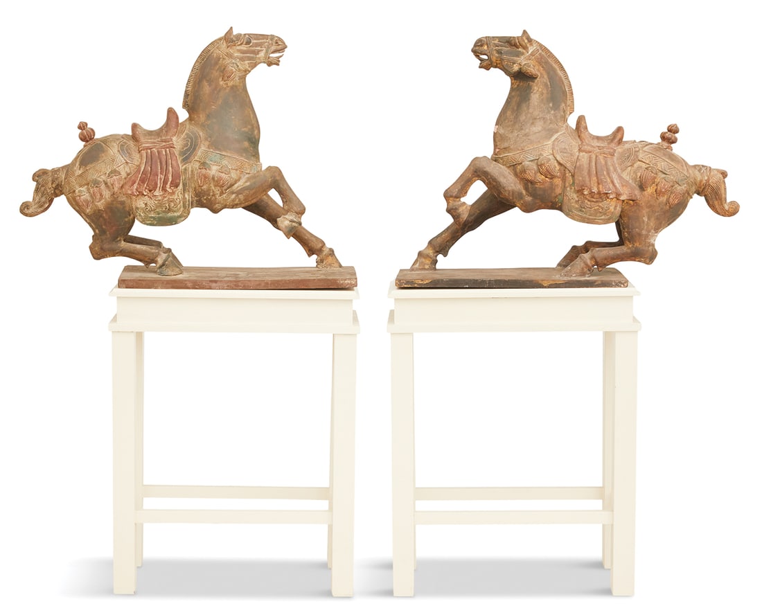 Pair of Tang-Style Wooden Horses on Stands: Pair of Tang-Style Carved and Painted Wooden Horses on Stands the classic horses modeled in an animated style, with saddles and tasseled tack, painted in gros rouge, displayed on painted parsons-style