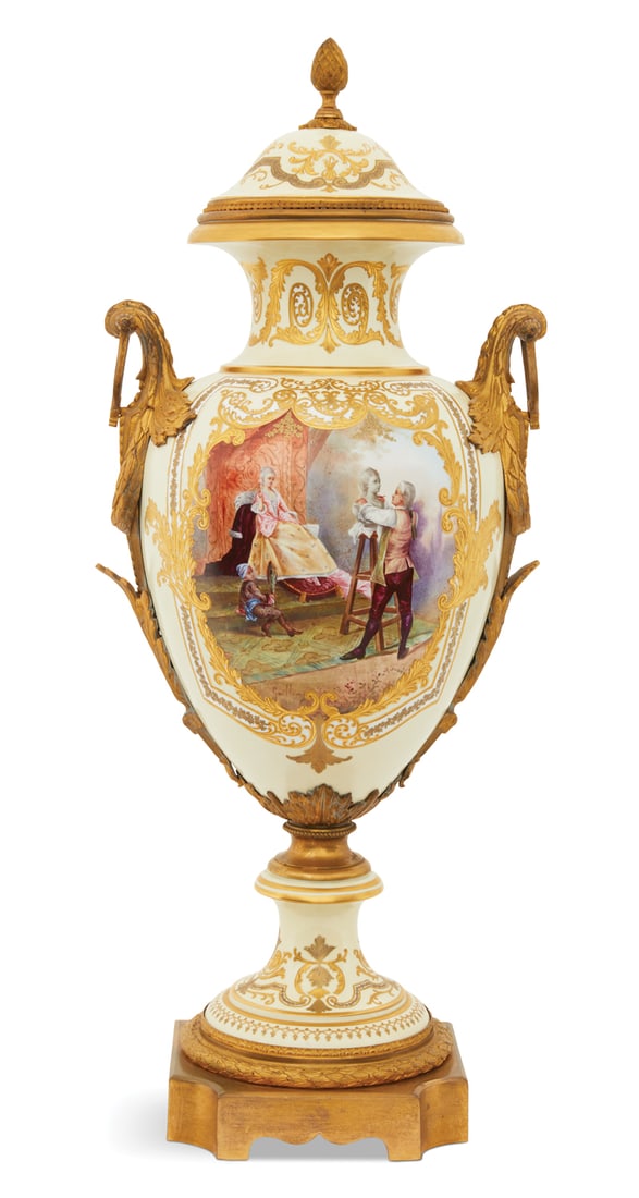 French Bronze-Mounted Porcelain Revolving Urn: French Bronze-Mounted Porcelain Revolving Urn ca. 1900, in the Sevres taste, the ogee cover with a pineapple knop, the body with raised gilt scrollwork on a cream-colored ground, the obverse decorated