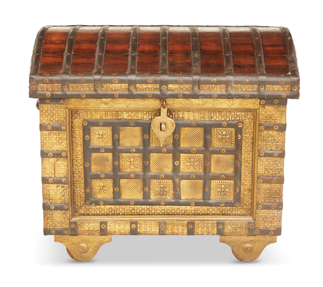 Anglo-Indian Tooled Brass and Hardwood Trunk: Anglo-Indian Tooled Brass and Hardwood Trunk 20th century, having a domed top with iron strapwork, tooled brasswork on the front and corners with additional strapwork, the ends with wrought iron swing