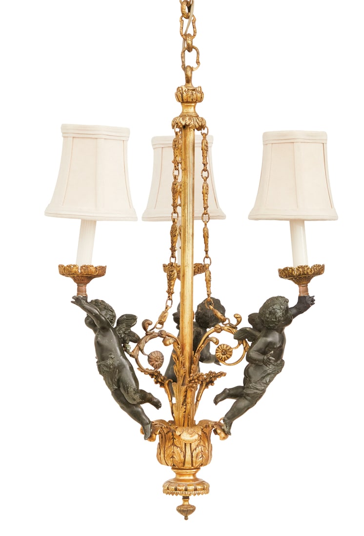 French Bronze and Patinated Metal Chandelier: French Gilded Age Bronze and Patinated Metal Chandelier ca. 1900, the three-light chandelier with a reeded standard set with leaf-molded scrolls, supporting patinated metal cherubs, holding aloft gilt