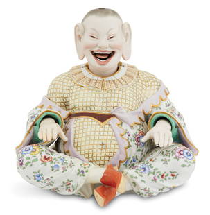 Meissen Porcelain Nodding Pagoda Figure: Meissen Porcelain Nodding Pagoda Figure 20th century, the seated, grinning figure fitted with a head set with an interior weight, so that the head, tongue and hands are articulated, dressed with a ruf