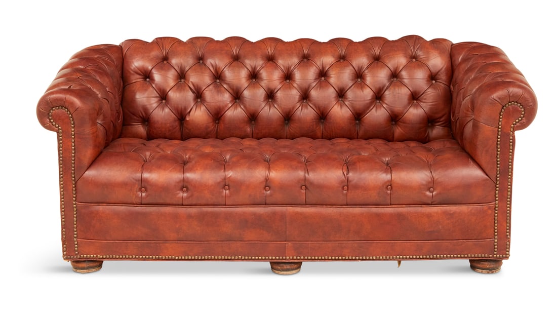 Diminutive Faux Leather Chesterfield Sofa: Diminutive Faux Leather Chesterfield Sofaof traditional form with a tufted back, seat and arms, raised on turned bun feet.h. 28", w. 68", d. 34"