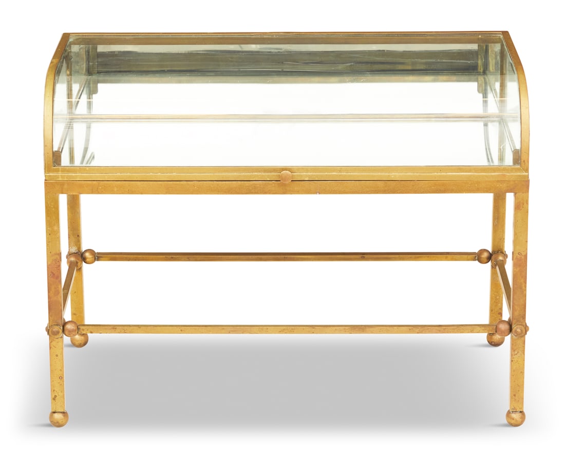 Unusual Brass and Glass Table-Form Vitrine: Brass and Curved Glass Table-Form Vitrineearly 20th century, the curved glass lid opening to an interior with a mirrored back and bottom, raised on square tubular legs joined by similar tubular stretc