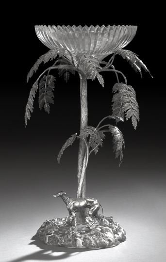 Victorian Silverplate Centerpiece: Victorian Silverplate Centerpiece, fourth quarter 19th century, in the manner of Elkington, depicting a greyhound beneath a tree, all on a rocky crag, the tree branches surmounted by a glass bowl deco