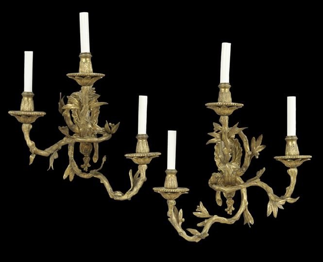 Pair of Three-Light French Gilt-Bronze Sconces: Pair of Unusual Three-Light French Gilt-Bronze Sconces, fourth quarter 19th century, the pierced rococo backplate supports three "rustic" patterned branches decorated with applied leaves and buds, lea