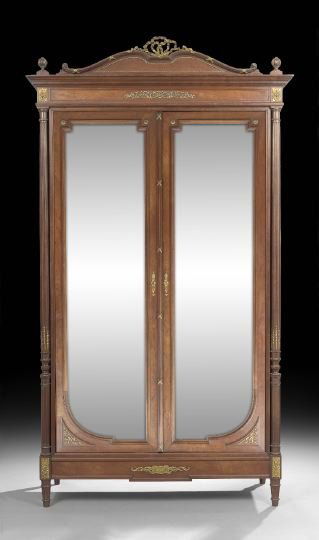 Louis XVI-Style Gilt-Bronze Mounted Armoire: Louis XVI-Style Mahogany and Gilt-Bronze Mounted Armoire, ca. 1900, the arched crest with cast gilt-bronze ribbon cartouche and applied beading above a pair of beveled mirror doors flanked by fluted c