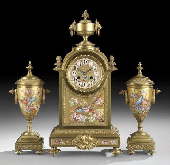 French Gilt-Bronze and Porcelain Garniture Set: Impressive French Gilt-Bronze and Porcelain Mantel Garniture Set, fourth quarter 19th century, the bronze clock case of Louis XIV-form, with reeded bun feet supporting the casket-shaped case, the lowe