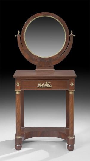 Empire-Style Mahogany Dressing Table: Empire-Style Mahogany Dressing Table, early 20th century, the circular mirror within an ormolu slip and mahogany frame, held by a demi-lune support, the rectangular top above a frieze fitted with a si