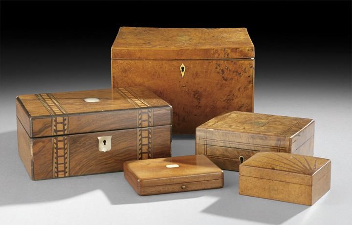 Collection of Five English Wooden Boxes: Collection of Five English Wooden Boxes, the first, first quarter 19th century, a Regency jewel box in burl walnut with an ivory escutcheon and resting on bun feet, the interior with a tray over a lar