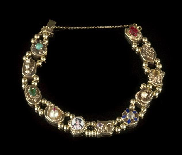 Lady's Fourteen-Karat Yellow Gold Slide Bracelet: Lady's Fourteen-Karat Yellow Gold Slide Bracelet, composed of eleven slides separated by yellow gold beads, the slides set with different gems (pearls, amethyst, moonstone, ruby, synthetic stones and