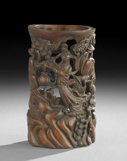Chinese Carved and Pierced Bamboo Brush Pot: Chinese Carved and Pierced Bamboo Brush Pot, 20th century, figure of a female immortal holding a lamp accompanied by two cranes in a forested mountain landscape, h. 8-1/2".