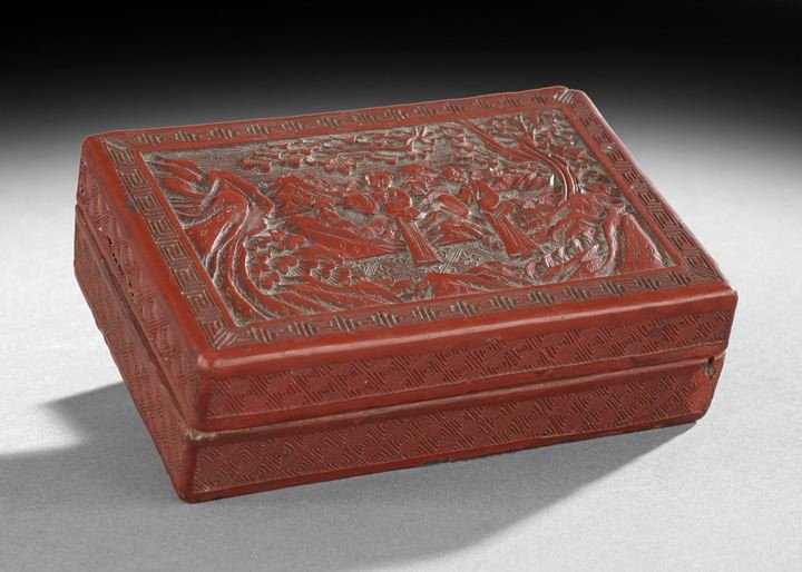 Chinese Carved Cinnabar Lacquered Box: Chinese Carved Cinnabar Lacquered Box, early 20th century, scene of two figures in a garden, h. 1-3/4", w. 4", l. 5-3/4".