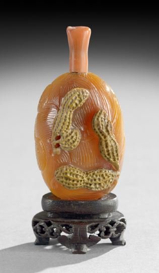 Chinese Carnelian Snuff Bottle: Chinese Carnelian Snuff Bottle, 19th century, surface-skin-carved as peanuts, body-carved with a swirling pattern, well-hollowed, coral stopper, h. 1-3/4".
