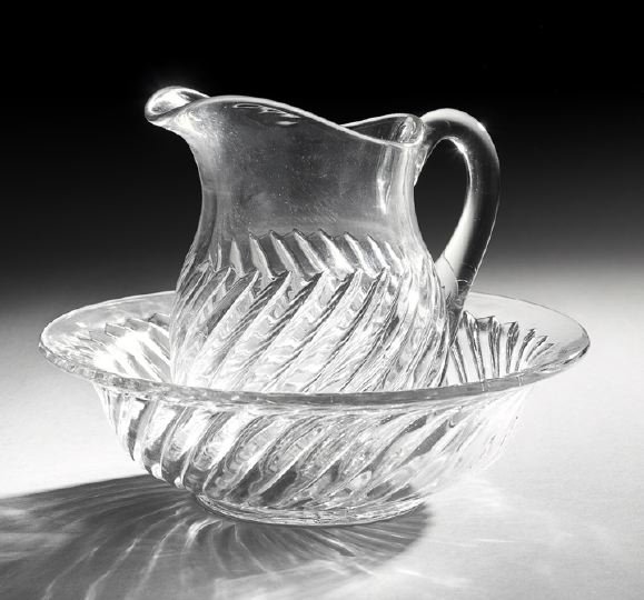 French Gadroon-Molded Colorless Glass Wash Set: French Gadroon-Molded Colorless Glass Wash Set, fourth quarter 19th century, the flaring bowl with a star-molded base, the vase-shaped ewer with an applied blown handle and a base matching the bowl, b