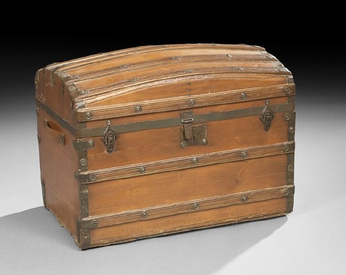 Pine, Hardwood and Iron Domed Trunk: Pine Hardwood and Iron Strapwork and Embossed Iron Domed Trunk, fourth quarter 19th century, the hinged top opening to reveal a compartmentalized interior, lined in paper printed in floral decor, h. 2