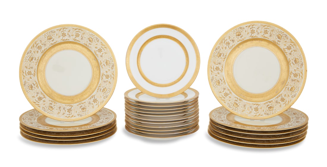 Eleven Heinrich & Co. Raised Gilt Dinner Plates: Eleven Heinrich & Co. Raised Gilt Dinner Platesfirst quarter 20th century, the plates with elaborately scrolled borders and accented with flowers on a cream ground, marked on the back by the retailer,