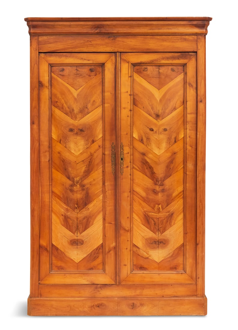 French Provincial Fruitwood Armoire: French Provincial Fruitwood Armoire 19th century, the book-matched paneled doors under a removable ogee crown, and over a molded base, the interior with a belt of drawers. h. 85", w. 53", d. 23"