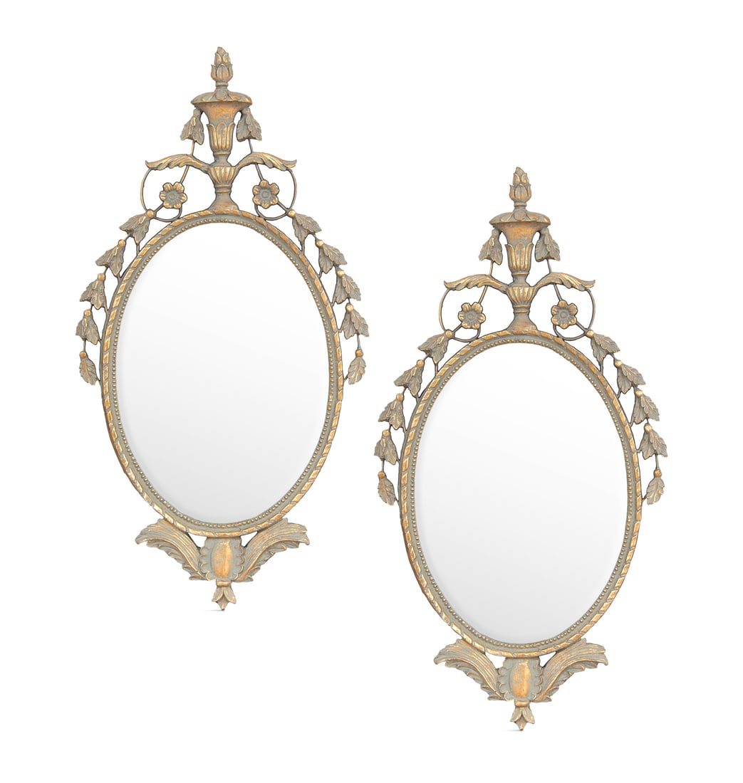 Pair of George III-Style Looking Glasses: Pair of George III-Style Polychrome Looking Glasses in the Adam taste, each with a beveled, ovoid mirror plate surmounted by a crest of an urn issuing a foliate garland, surrounded by an annulated and