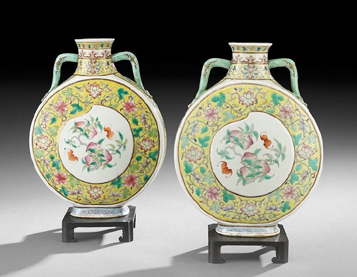 Pair of Chinese Porcelain Vases: Pair of Chinese Porcelain Vases, 19th century, pilgrim flask form with relief peach-shaped reserves decorated with bats and peaches, yellow ground decorated with floral scrolling, h. 10-3/4".