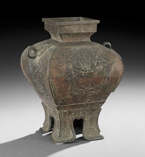 Chinese Bronze Vase: Chinese Bronze Vase, the pierced feet decorated with Chinese scrollwork supports, the sides, decorated with raised dragons and clouds, loop handles mounted on the side, the square, flaring neck decora