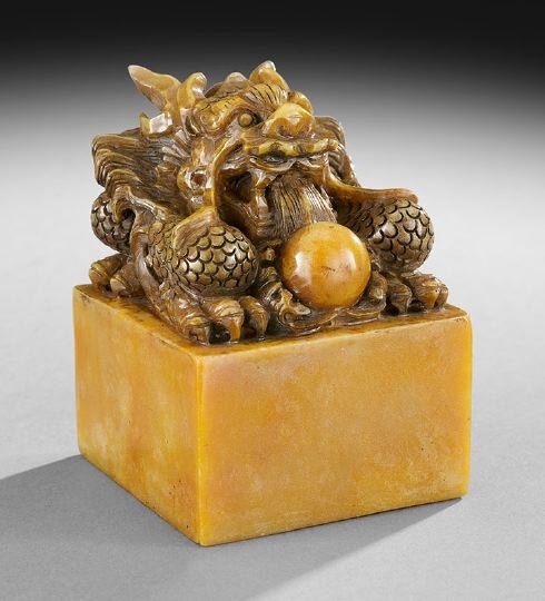 Chinese Soapstone Seal: Chinese Soapstone Seal, 20th century, the stone of a yellow color and finial carved as a dragon with a pearl, base with a Ch'ien Lung inscription, h. 5-3/4".