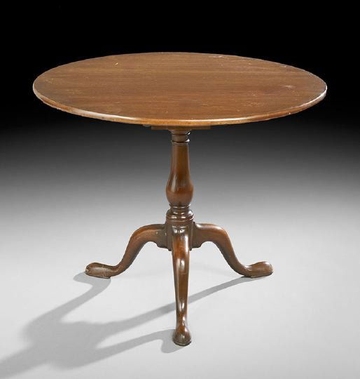 George III-Style Mahogany Tripod Table: George III-Style Mahogany Tripod Table, 19th century, the tilting circular top with a birdcage support raised on a turned vasiform standard to three splayed cabriole legs ending in pad feet, h. 28", d