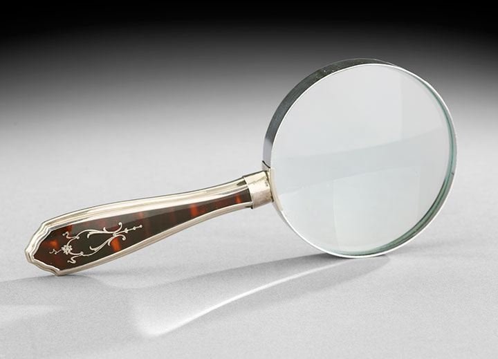 Magnifying Glass with Tortoiseshell Handle: Magnifying Glass with Sterling and Tortoiseshell Handle, the tapered handle, with a ferrule hallmarked by William Ellis & Co., Sheffield, England, 1927-28, the inset tortoiseshell inlaid with a silver