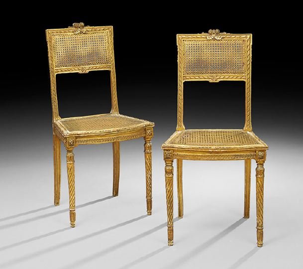 Pair of Louis XVI-Style Giltwood Sidechairs: Pair of Louis XVI-Style Giltwood Sidechairs, early 20th century, each with a caned back surmounted by a floral crest, the caned seat raised on circular tapering spiral-fluted legs ending in toupie fee