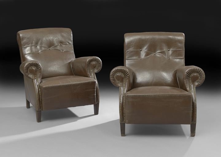 Pair of Edwardian Leather Upholstered Club Chairs: Pair of Edwardian Mahogany and Leather Upholstered Club Chairs, early 20th century, each with a padded back-scrolled, back-tufted and joined by rounded arms to the padded seat, the front with brass ta