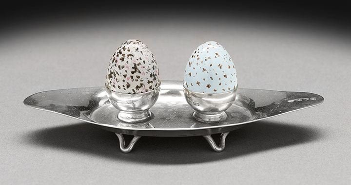 Edwardian Sterling Silver Salt and Pepper Stand: Amusing Edwardian Sterling Silver and Enamel Salt and Pepper Stand, hallmarked London, 1909-1910, by Blackburn & Co., the navette-shaped stand raised on four "V"-shaped wirework feet, the recessed ova