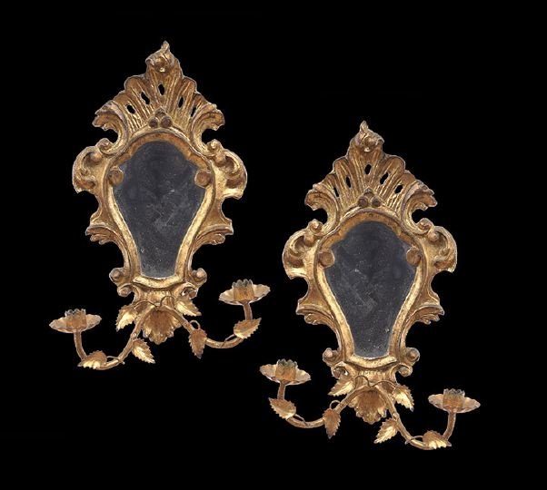 Pair of Italian Giltwood Rococo Mirrored Sconces: Pair of Italian Giltwood Rococo Mirrored Two-Light Sconces, each with mirrored backplates and a scrolled surround with a pierced shell-form crest, fitted with a pair of scrolled gilt-metal candle bran