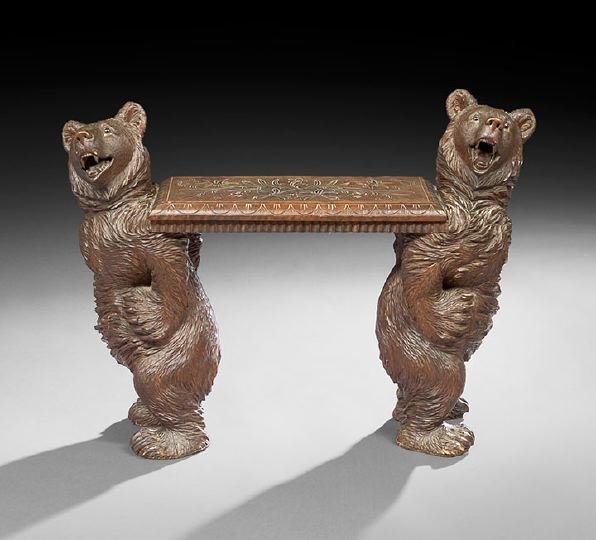 Black Forest Carved Lindenwood Bench: Black Forest Carved Lindenwood Bench, late 19th century, the rectangular seat with incised scrolling foliate patterns, supported to each end by a well-carved figure of a bear, with inset glass eyes, h